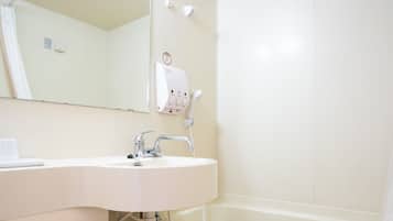A bathroom with a toilet, sink, and bathtub.