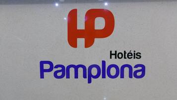 A sign with the HP logo and the words "Hotéis Pamplona" indicating a hotel named HP.