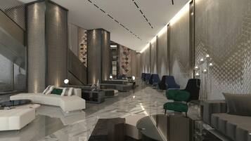 A modern lobby with a curved white sofa, a staircase, and a patterned wall.