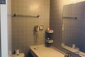 A bathroom with a toilet, a sink, a mirror, a towel rack, and a phone. - Jinjiang (Anqing Dananmen Daopashi Ancient Street) (Anqing)