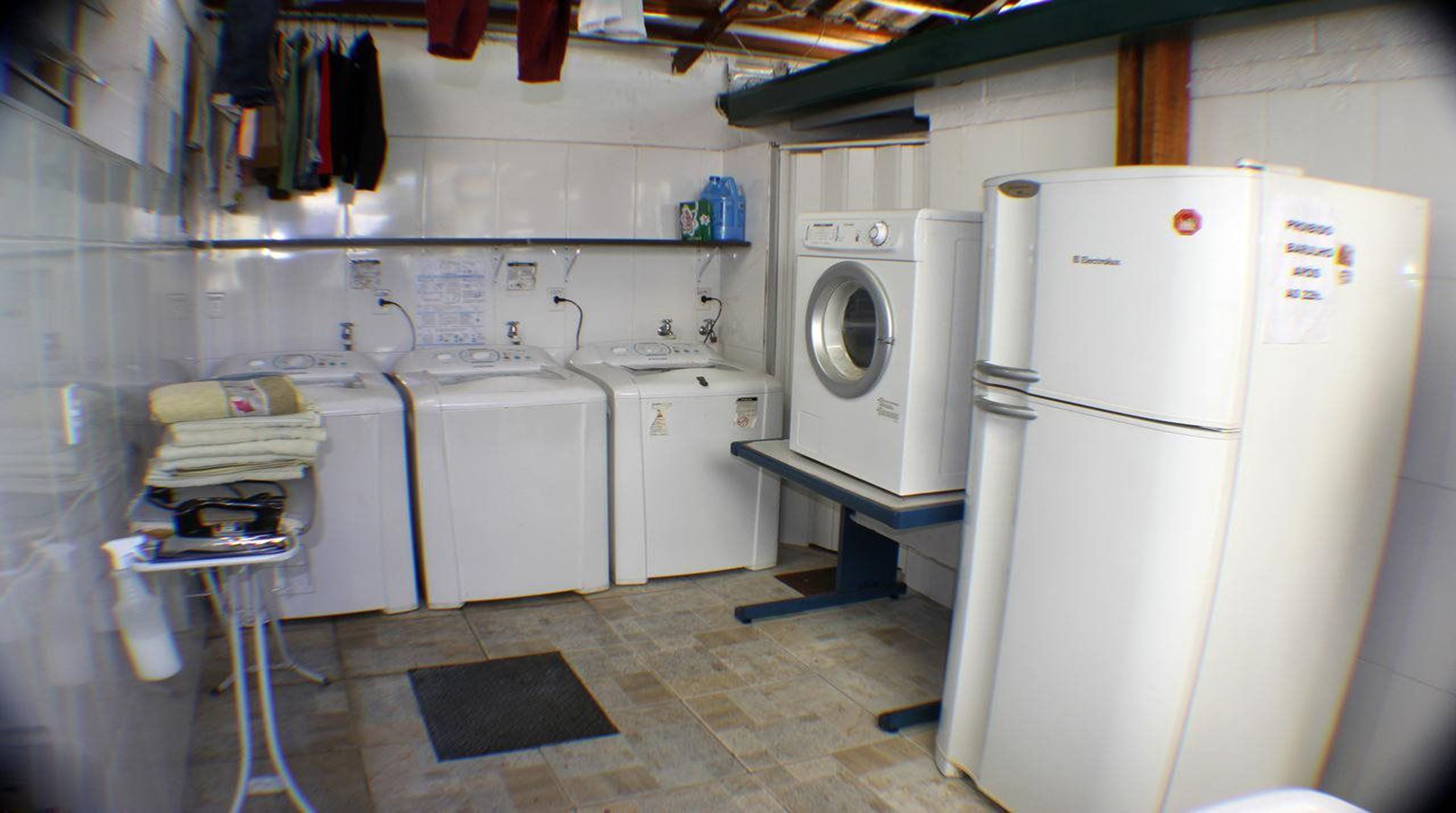 A compact laundry room with a washing machine, dryer, and refrigerator.