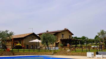 Outdoor pool, an infinity pool, pool umbrellas, pool loungers