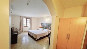 A bedroom with a bed, a wardrobe, a desk, and a chair. - Asuncion House (Asunción)