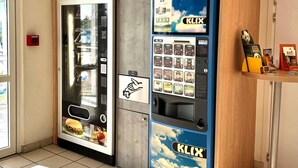 A vending machine with a blue and white design, featuring a variety of beverage options and a Mars ice cream dispenser. - ibis budget Cosne-sur-Loire (Cosne-Cours-sur-Loire)