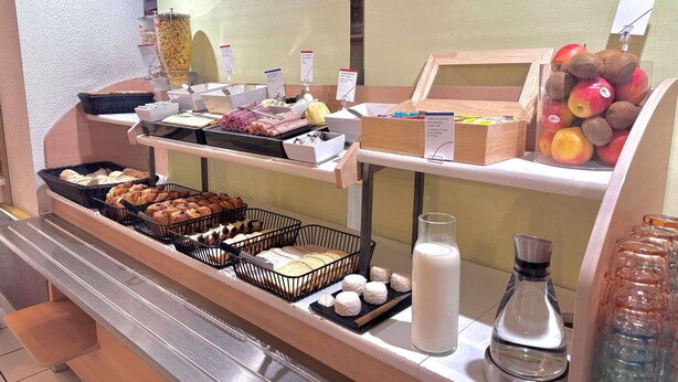 A breakfast buffet with various food items and a coffee station. - ibis budget Cosne-sur-Loire (Cosne-Cours-sur-Loire)