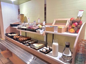 A breakfast buffet with various food items and a coffee station. - ibis budget Cosne-sur-Loire (Cosne-Cours-sur-Loire)
