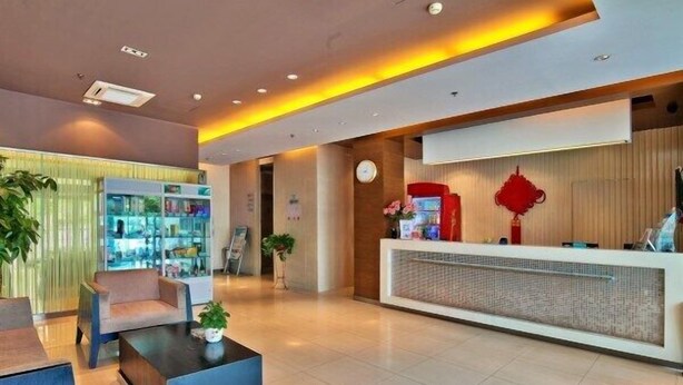 A modern reception area with a reception desk, seating area, and a glass display case.