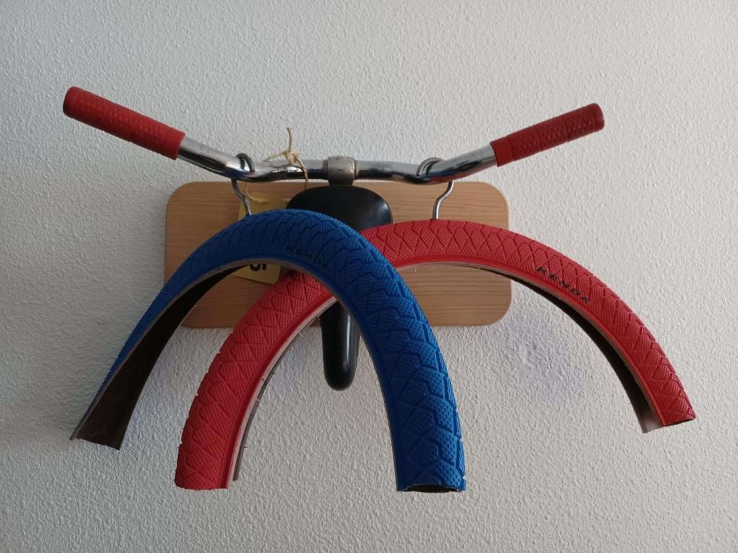 Una bicicleta fijada a la pared con una base de madera.