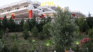 A modern hotel with multiple balconies and a prominent 'HOTEL' sign.