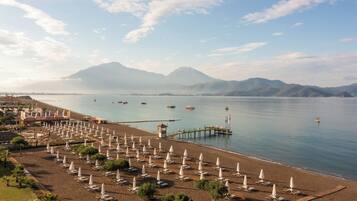On the beach, sun-loungers, beach umbrellas, beach towels