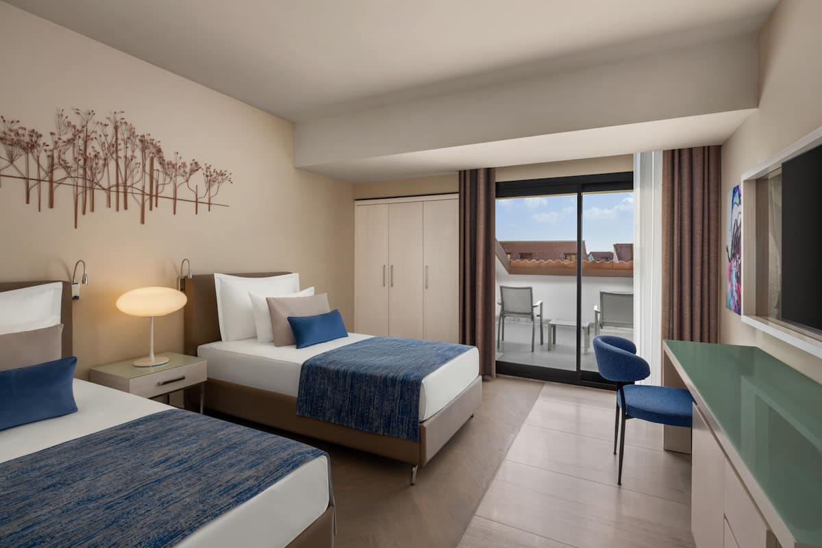 Superior Family Room with Partial Sea View | Free minibar, in-room safe, desk, iron/ironing board