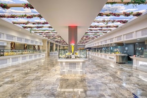 A spacious atrium with a high ceiling, a central fountain, and a glass railing along the sides. -  Akra Fethiye Tui Blue Sensatori All Inclusive (Fethiye)