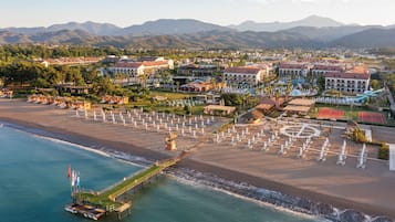 On the beach, sun-loungers, beach umbrellas, beach towels