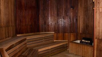 Relax in a cozy sauna with a bench and storage for essentials.
