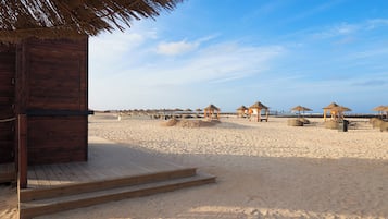 On the beach, sun loungers, beach umbrellas, beach towels