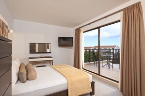 A hotel room with a bed, a TV, a desk, and a balcony with a table and chairs. - Melia Dunas Beach Resort & Spa - All Inclusive (Sal)