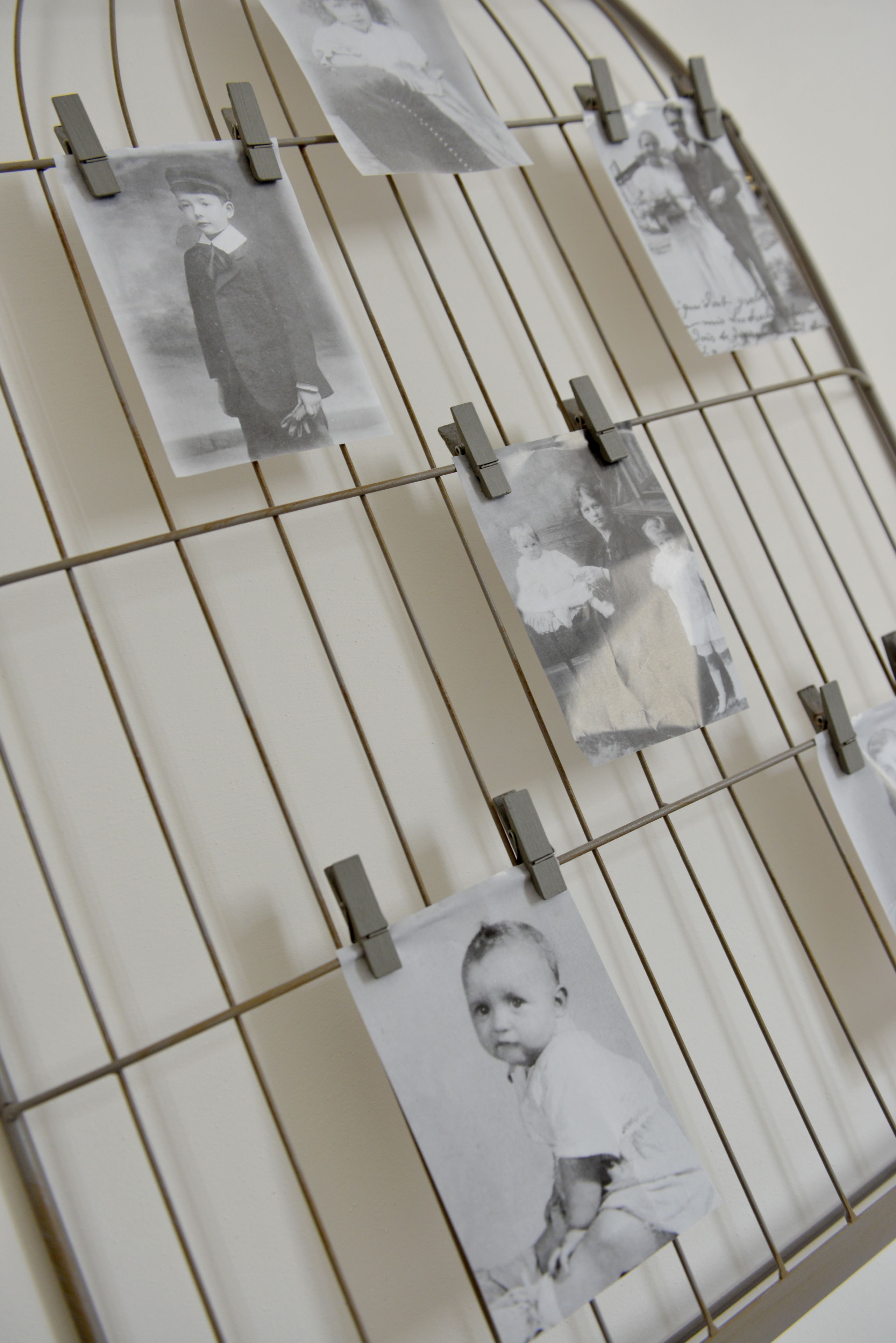 Una serie de fotografías en blanco y negro sujetas a una estructura de alambre.