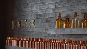 A wall with the word "UNIPER" and a row of bottles. - Andaz Delhi, by Hyatt (New Delhi)