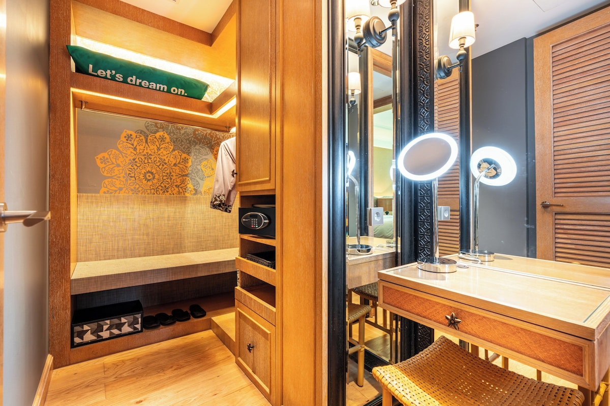 A compact, well-lit bathroom with a vanity, mirror, and storage cabinets.