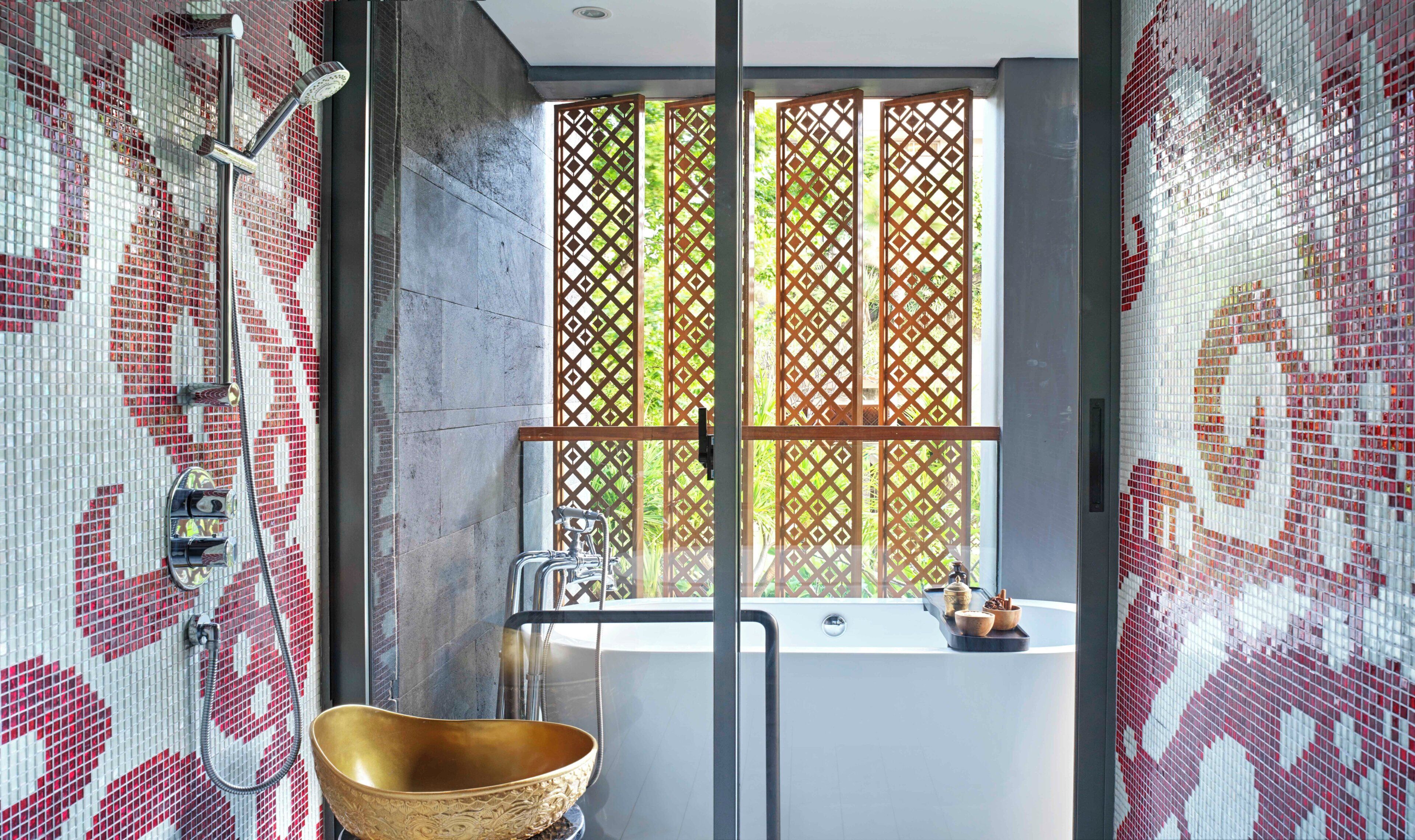 A bathroom with a large window, a gold basin, and a shower area.