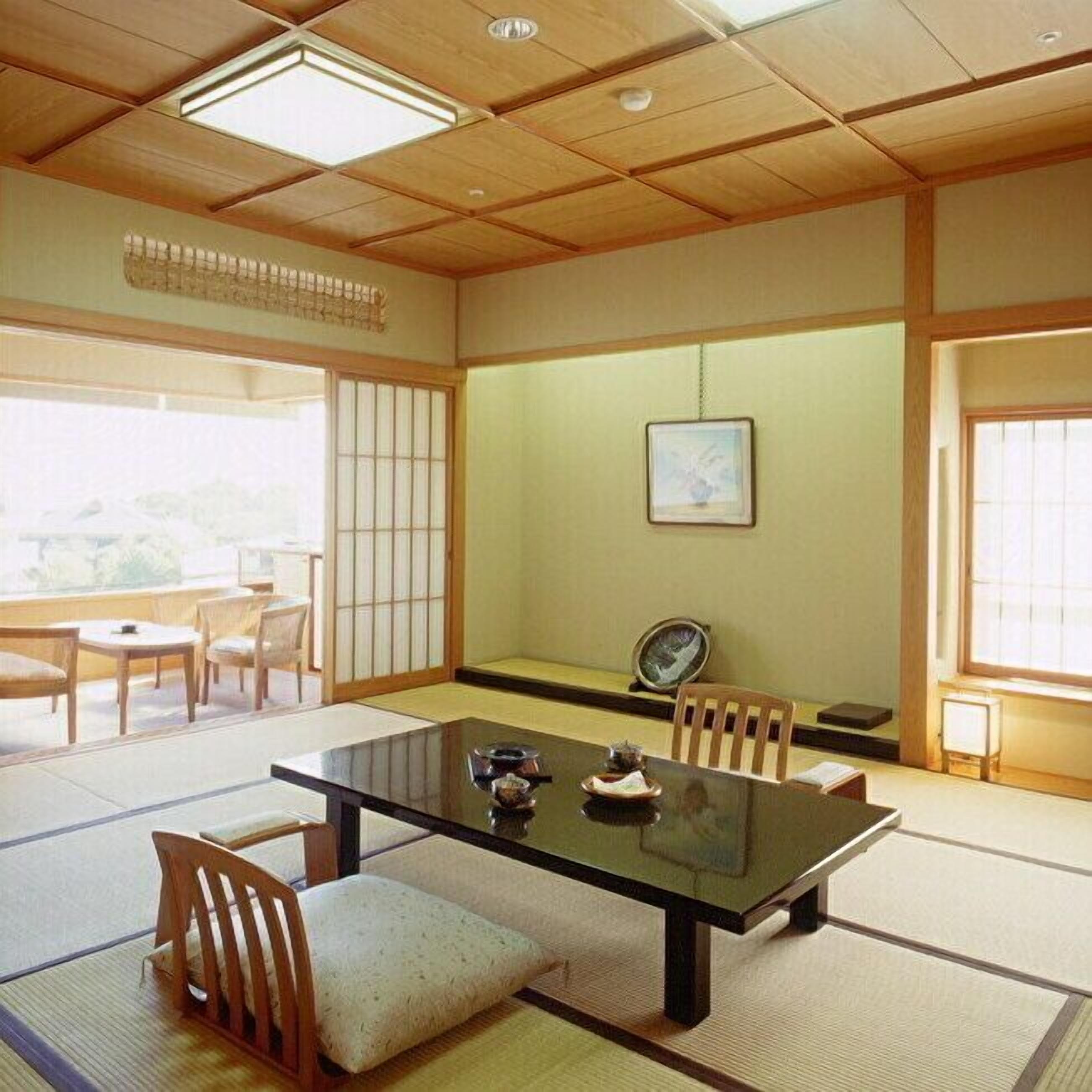 A traditional Japanese room with tatami flooring, a low table, and shoji screens.
