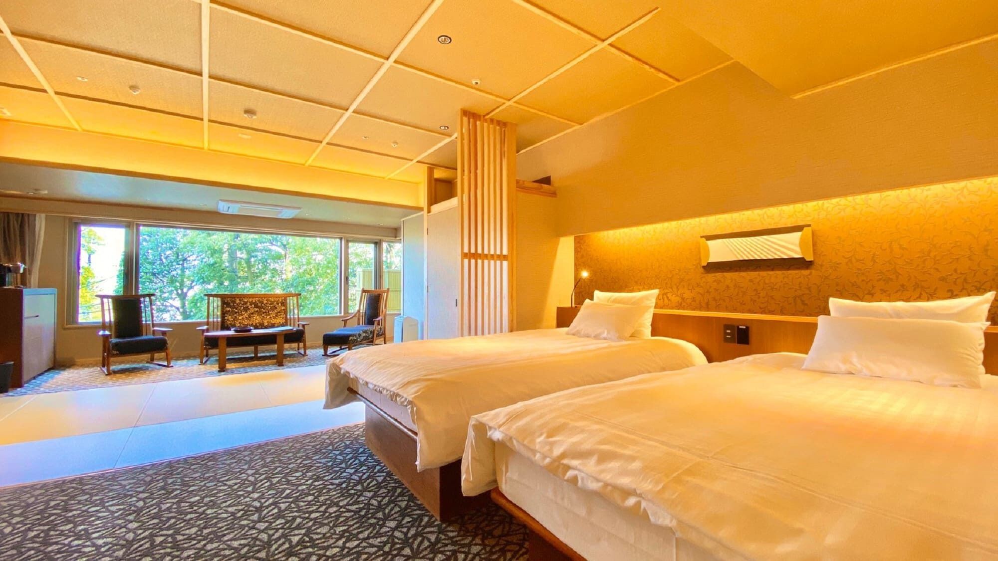 A hotel room with two beds, a desk, a chair, and a view of the outdoors.