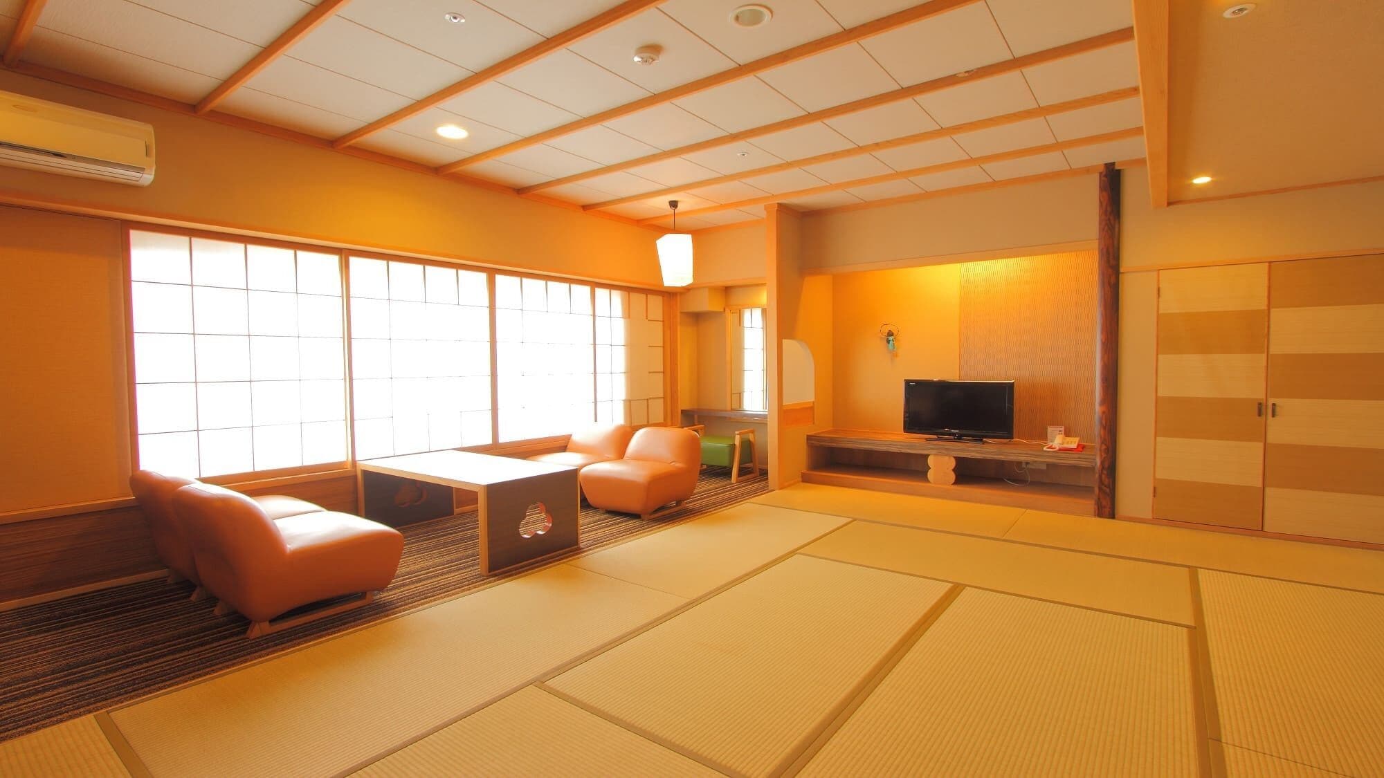 A traditional Japanese-style room with tatami flooring, a television, and sliding doors.
