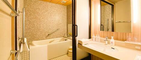 A modern bathroom with a bathtub, a shower, and a vanity with a mirror.