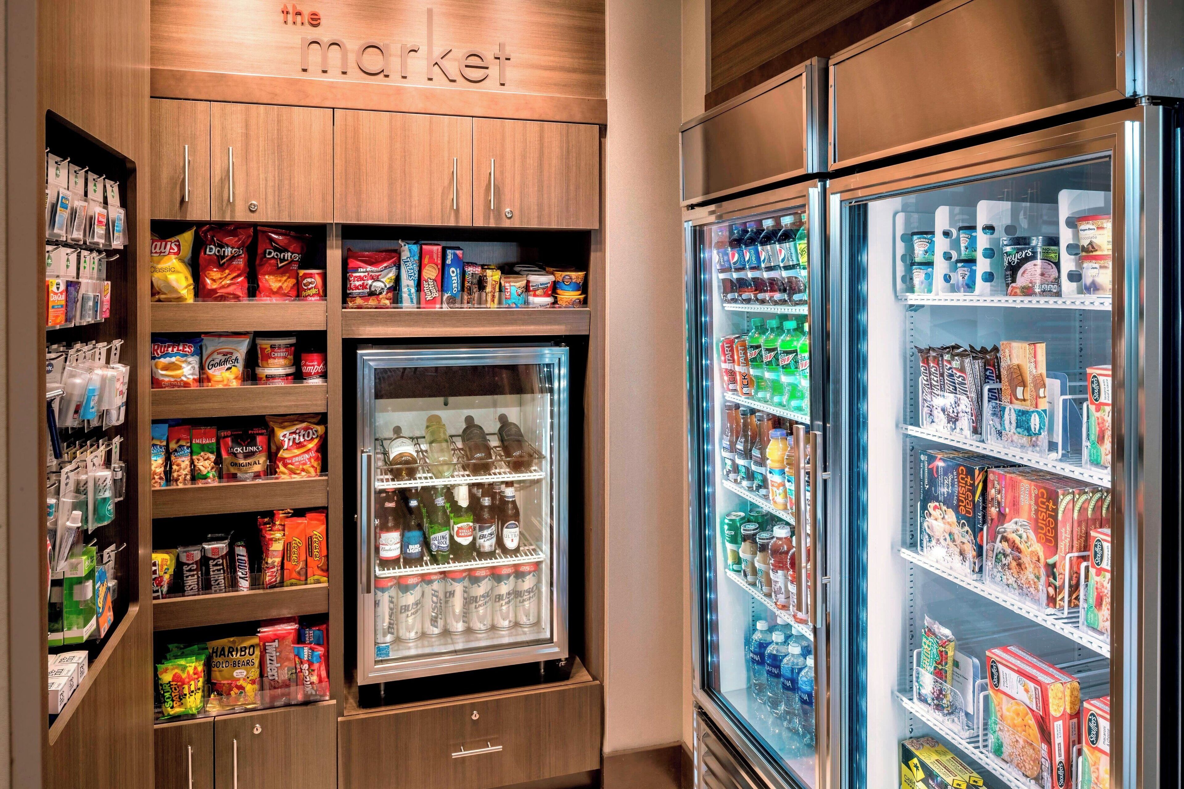 A self-service beverage and snack vending area with various brands and products.