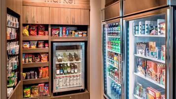 A self-service beverage and snack vending area with various brands and products.