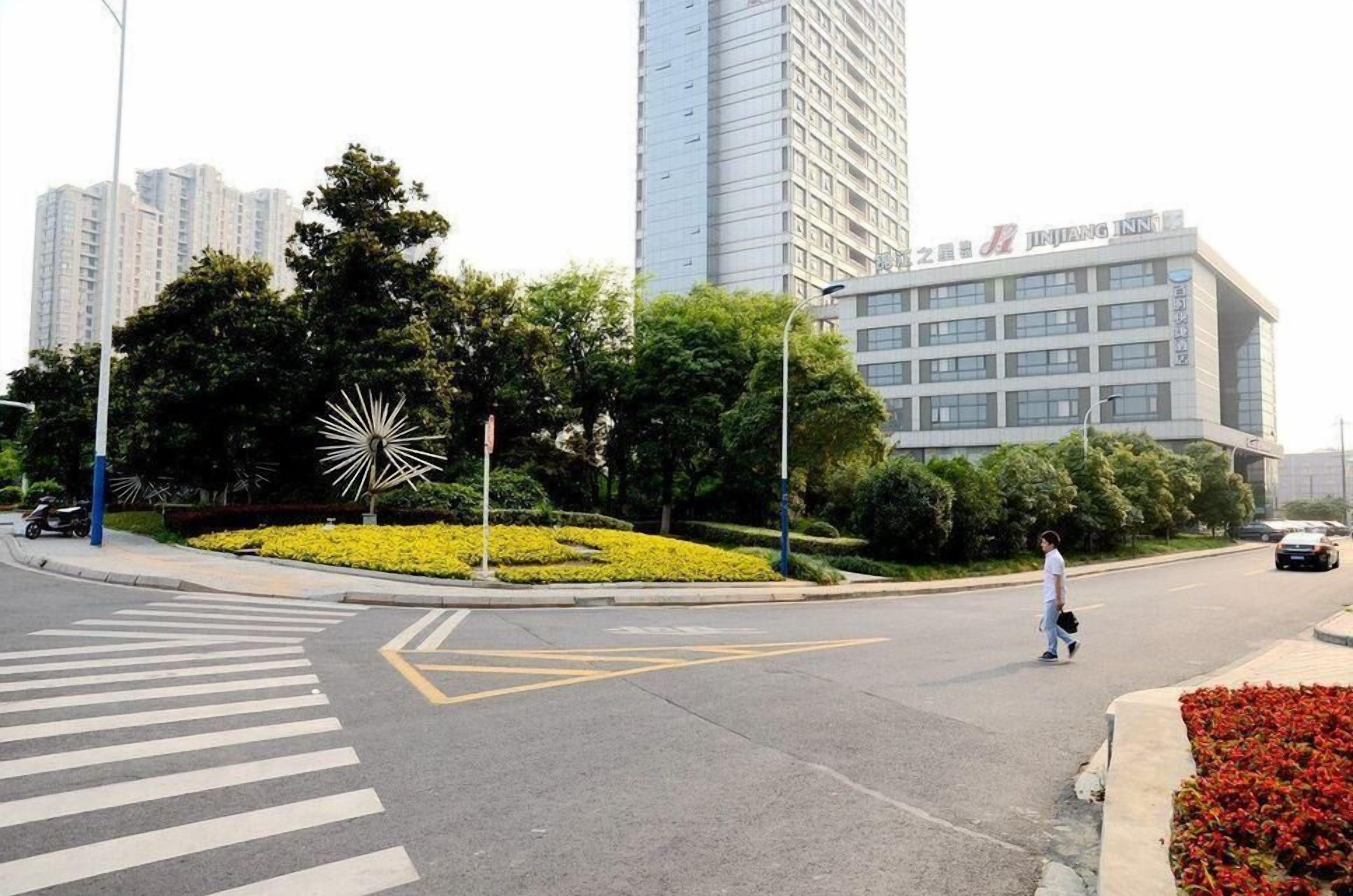 A modern building with a sign that reads "JINJANG INN".