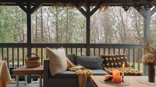 A cozy outdoor seating area with a sofa, a table, and a basket. -  Auberge Old Chelsea (Chelsea)