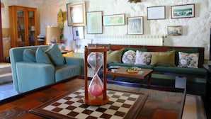 A living room with a checkered coffee table, two sofas, and an hourglass.