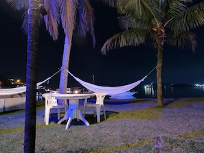 Relax under a shaded canopy with a serene waterfront view.