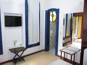 Enjoy a clean and modern space with a flat-screen TV, comfortable bench, and a convenient layout.