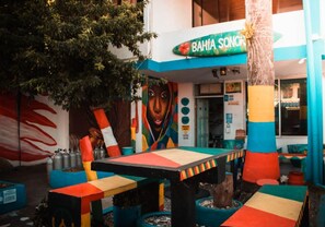 A colorful outdoor seating area with a mural and a sign that reads "BAHIA SONORO". - Posada Cultural Bahia Sonora (San Andrés)