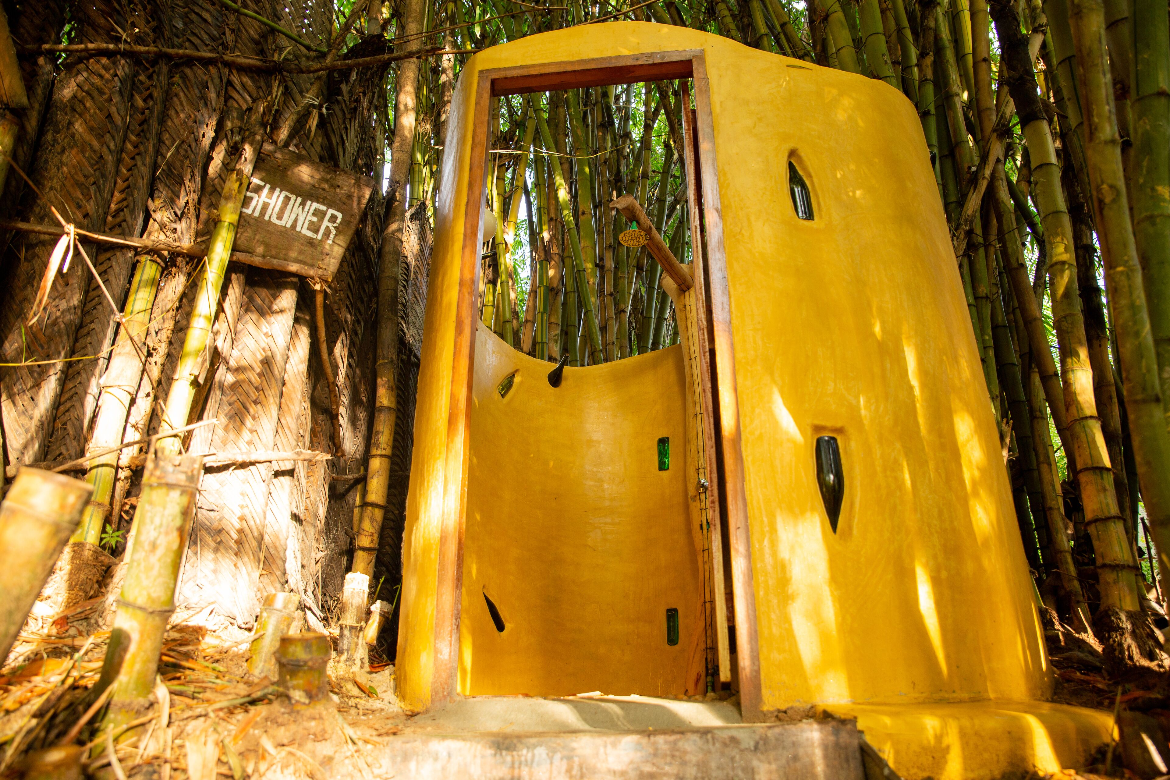 A yellow structure labeled "SHOWER" in a bamboo forest.
