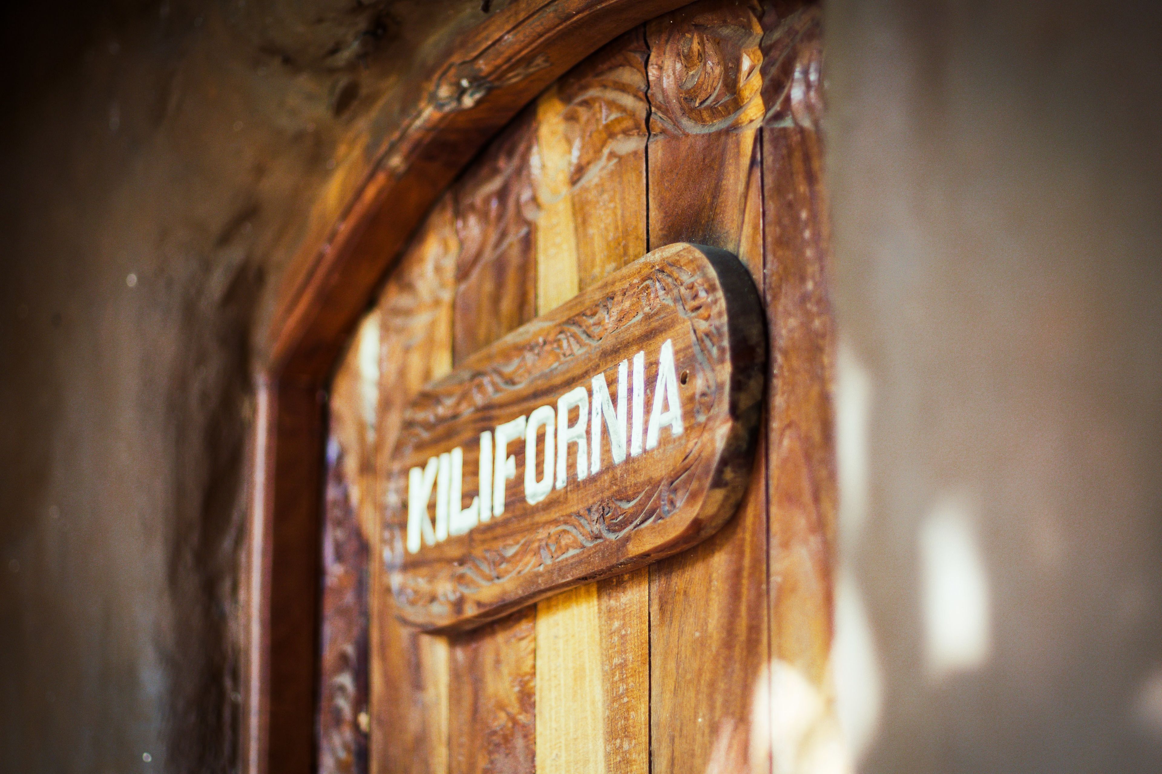 Une porte en bois sur laquelle est gravé le mot « KILIFORNIA ».