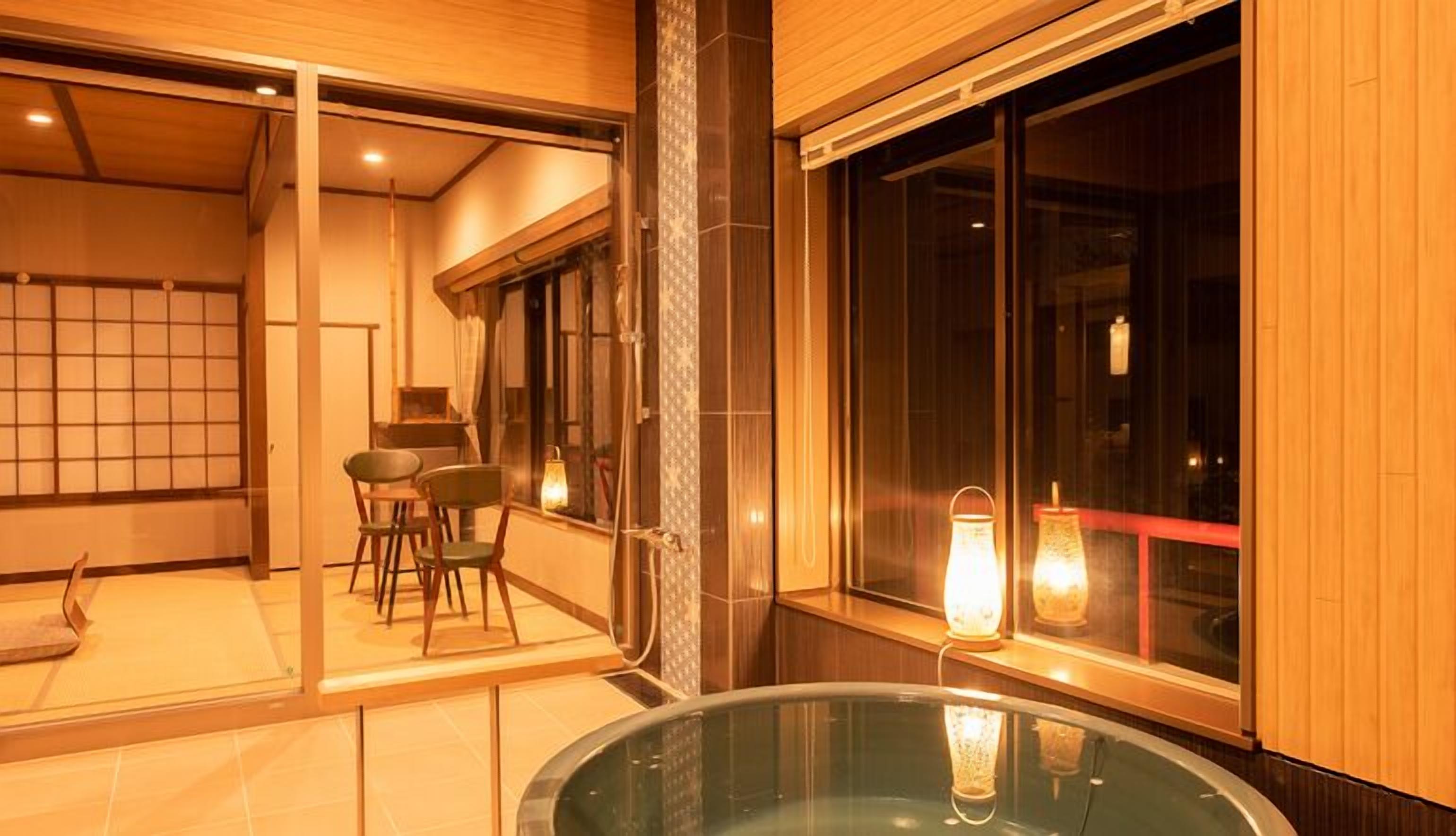 A modern interior with a glass table, wooden flooring, and a view of the outside.