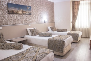 A hotel room with three beds, patterned bedspreads, a painting on the wall, and a window with curtains. - Elite Marmara Residence (Istanbul)
