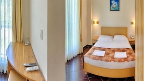 A hotel room with a bed, bedside tables, a desk with a chair, and a painting on the wall. - Sirena Hotel (Podgora)