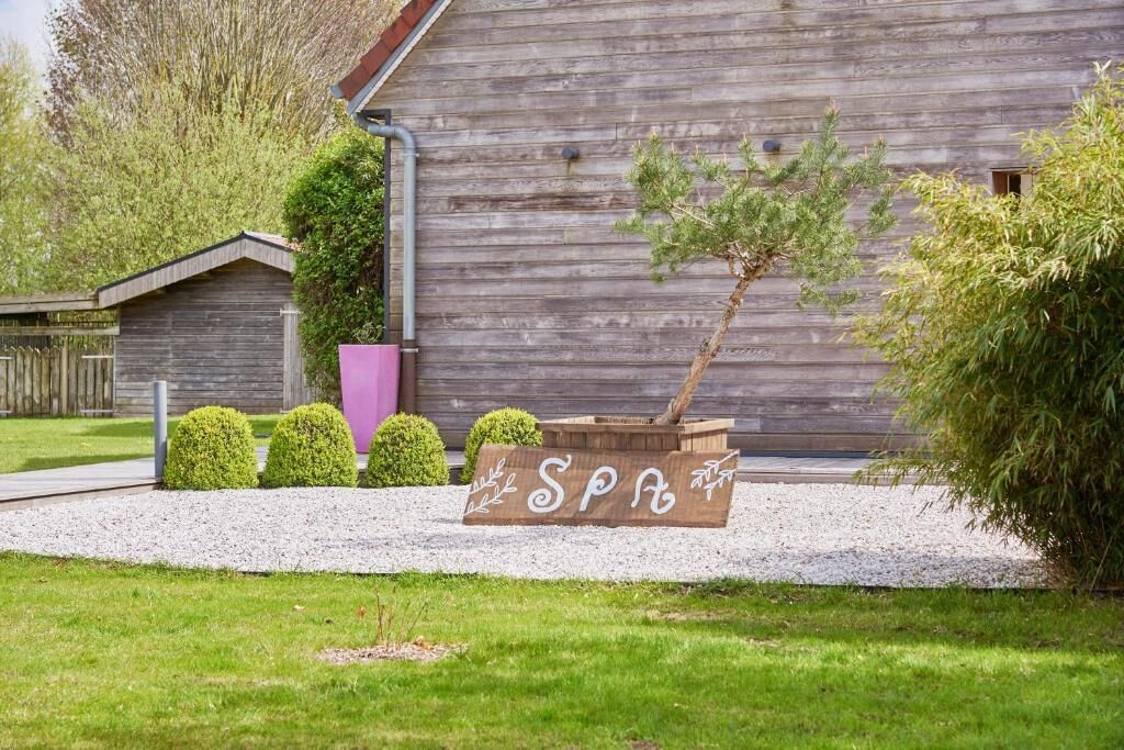 A wooden building with a sign that reads 'SPA' in the foreground.