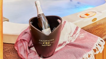 A hot tub with a bottle of champagne in a bucket.