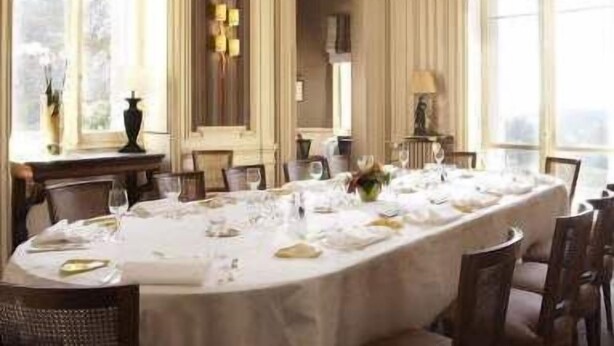 A formal dining room with a long table set for a meal, elegant chairs, and large windows providing natural light. - Domaine de la Tortinière (Veigne)