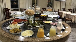 A buffet setup with various food items and beverages.