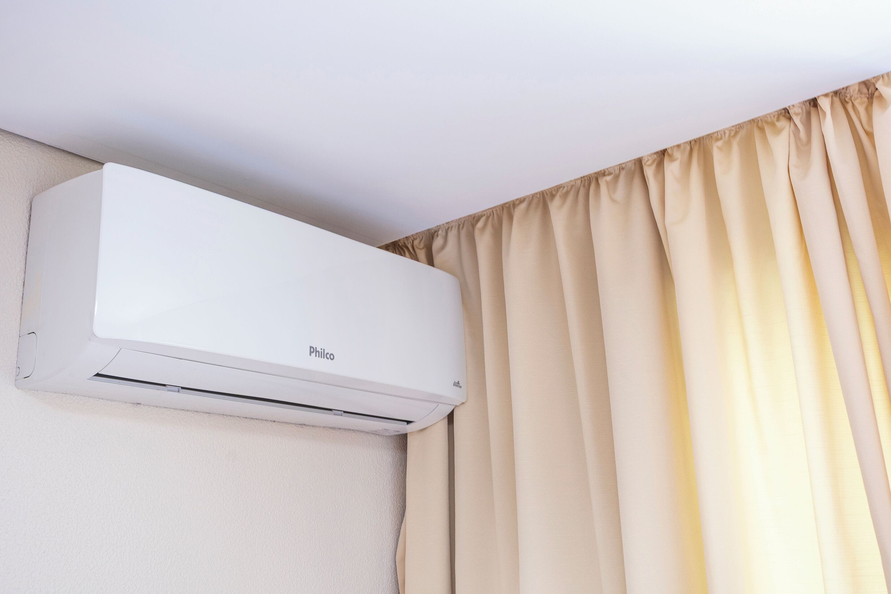 A white air conditioning unit mounted on a wall.