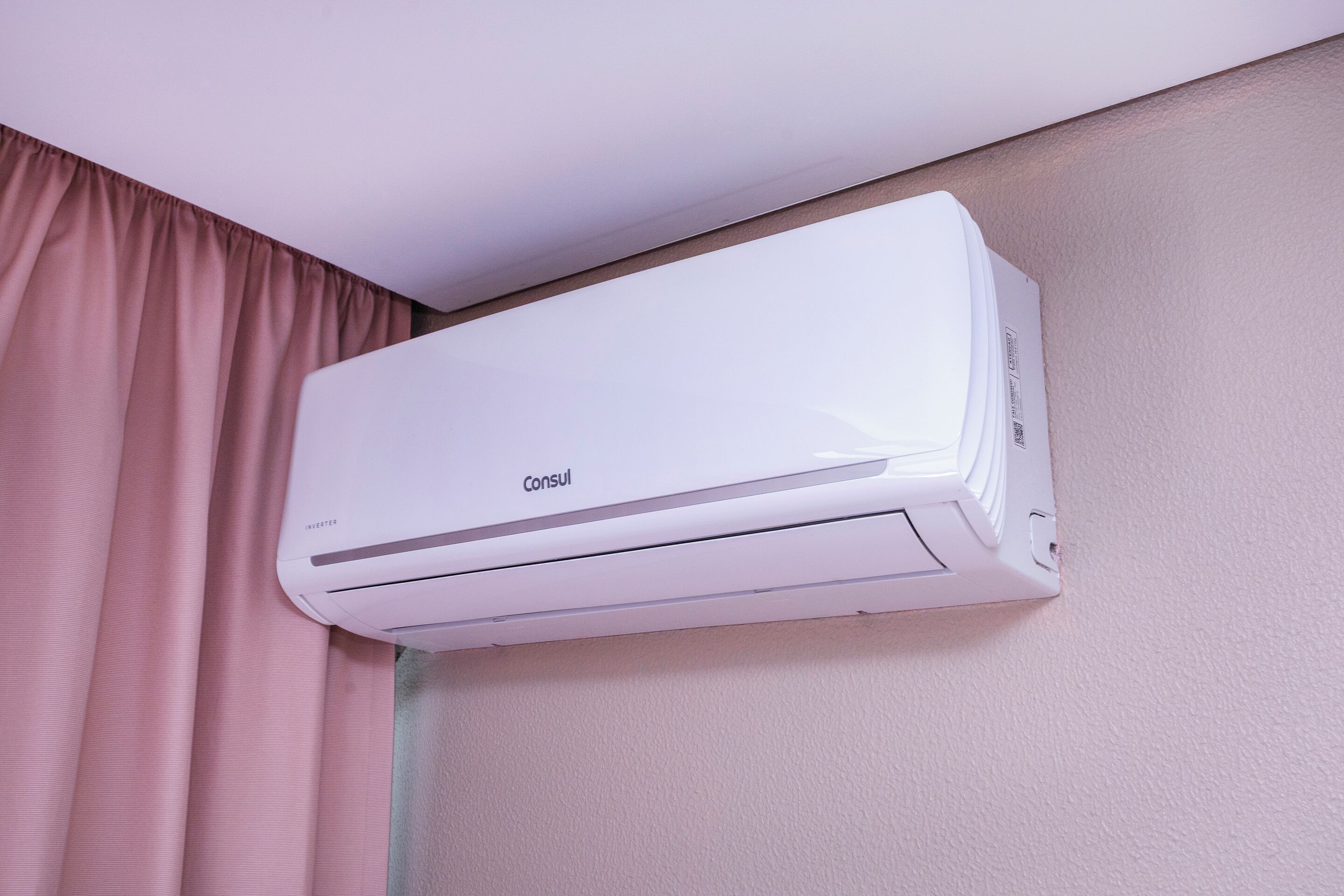 A white air conditioning unit mounted on a wall.