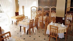 A dining area with multiple tables and chairs, arranged in a semi-circular pattern. - Hotel Dar El Aaz (Algiers)