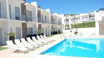 Seasonal outdoor pool, open 9:00 AM to 7:00 PM, pool loungers