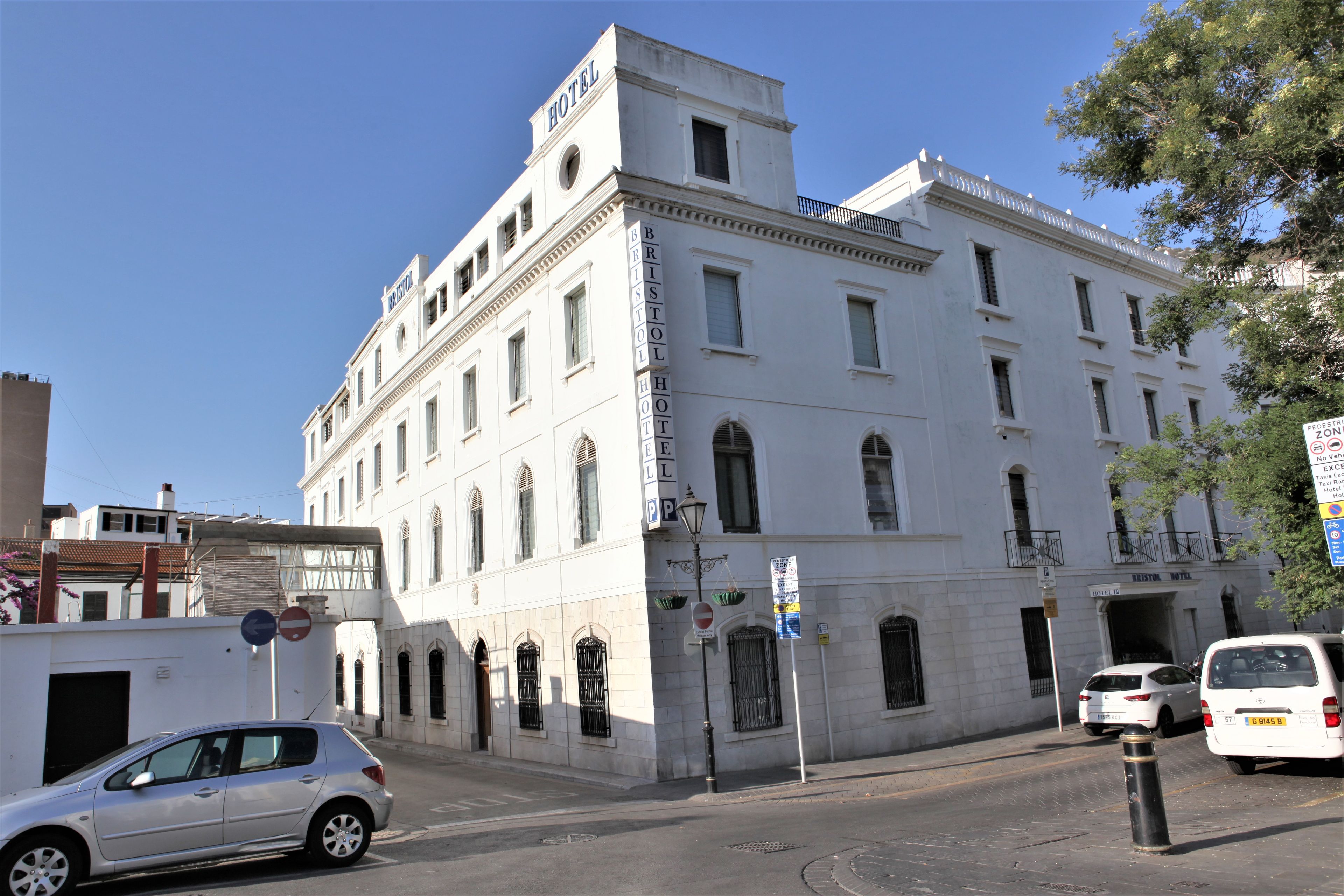 A historic building with a prominent 'HOTEL' sign, multiple windows, and a classic architectural style.